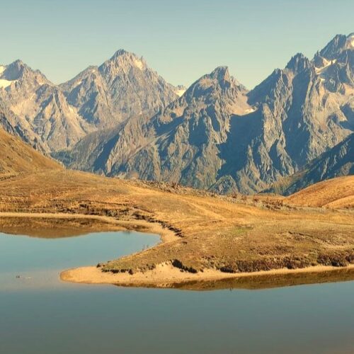 Scenic view of Koruldi alpine lakes reflecting the Caucasus mountain peaks in Svaneti, Georgia, on a grand adventure tour