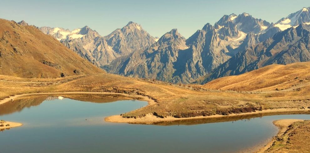 Scenic view of Koruldi alpine lakes reflecting the Caucasus mountain peaks in Svaneti, Georgia, on a grand adventure tour
