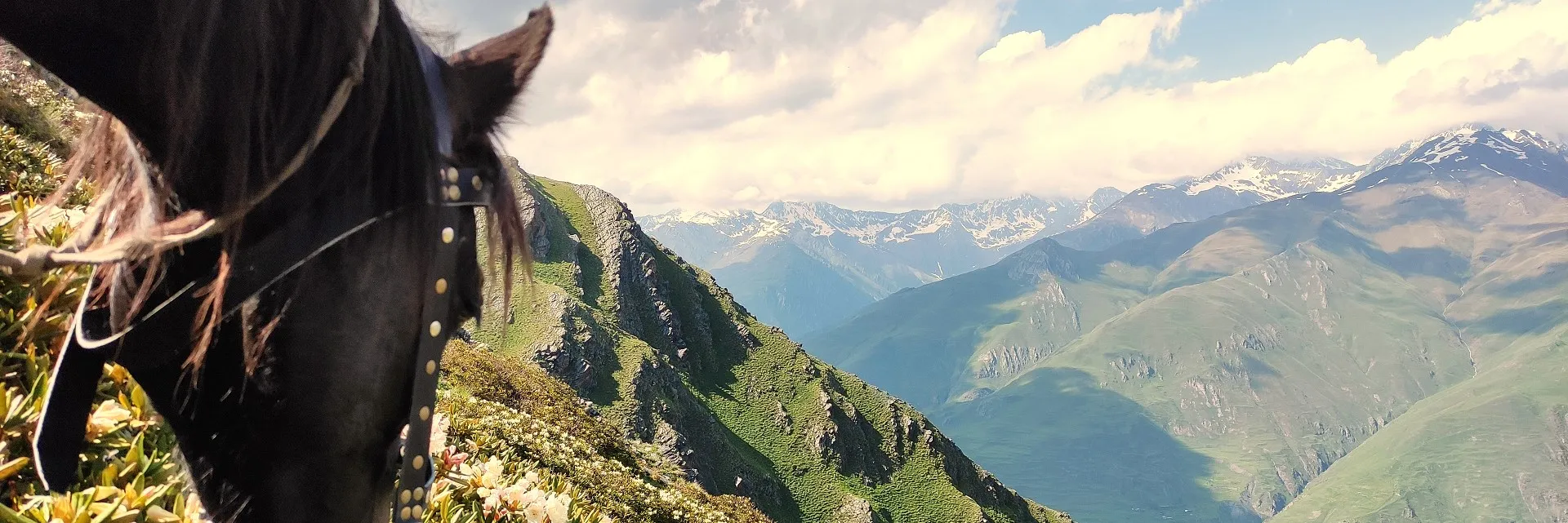 Panoramic view of the Pirikiti Valley from the Unagira mountain range in Tusheti, Georgia, during a high-altitude trekking tour.