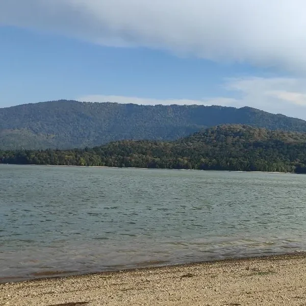 Shaori reservoir in Racha, Georgia, surrounded by forested mountains.