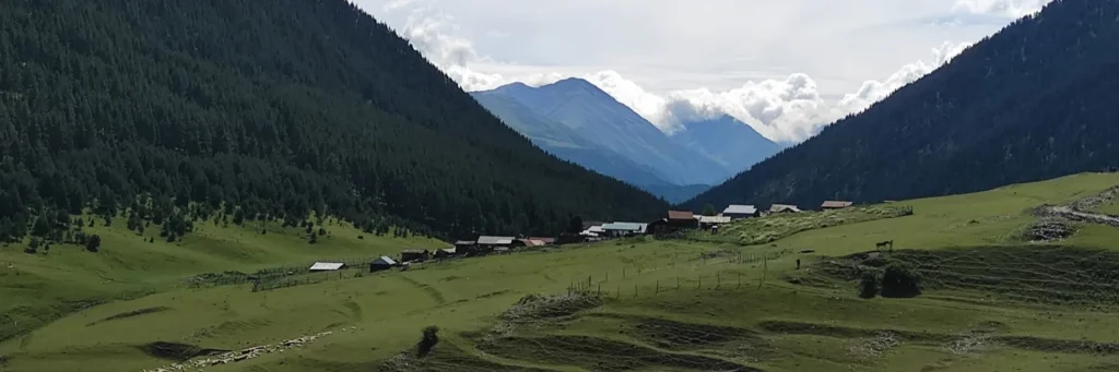 Panoramic landscape of Diklo village nestled in a green valley in Tusheti