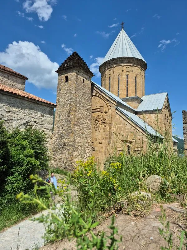 Medieval stone watchtower and carved stone facade of the Church of the Assumption at Ananuri Fortress