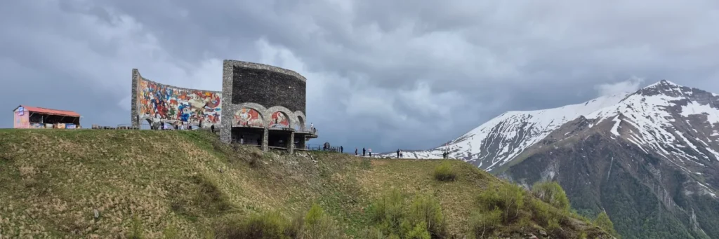 Scenic view of the Russia-Georgia Friendship Monument perched on cliffs in Gudauri Georgia
