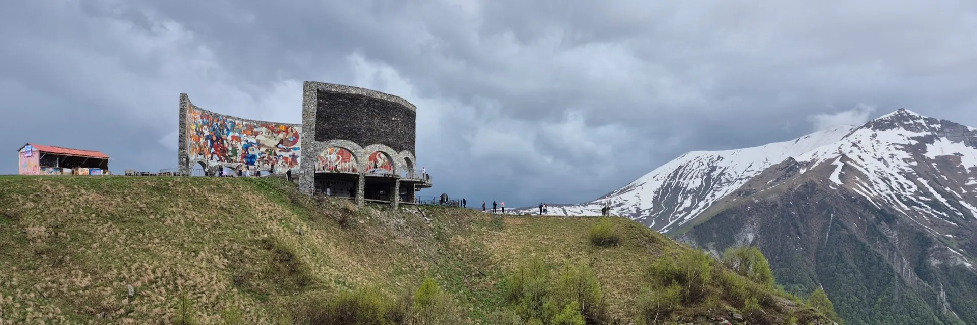 Scenic view of the Russia-Georgia Friendship Monument perched on cliffs in Gudauri Georgia