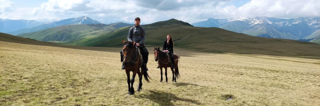 Horseback riding in Tusheti across scenic alpine mountain ridges and plateaus