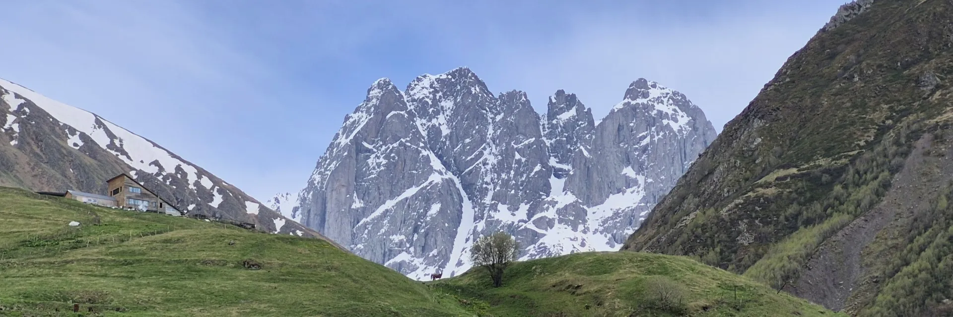 Scenic view of Juta village stone church and jagged peaks of Mount Chaukhebi in Kazbegi Georgia