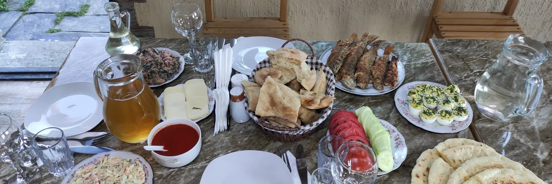 Traditional Tushetian food and mountain feast table at a local guesthouse in Omalo Tusheti