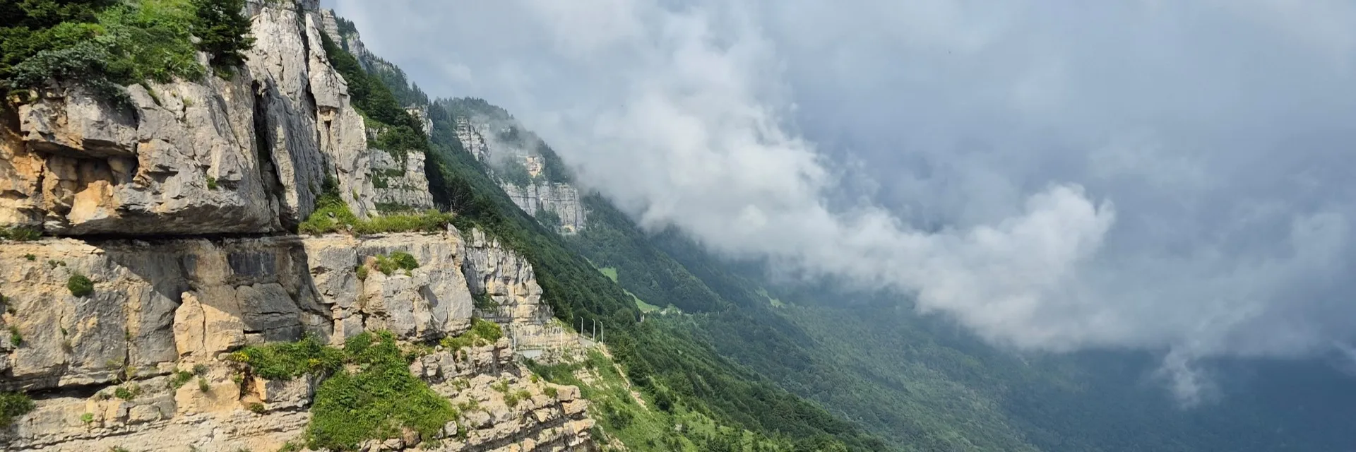 Massive limestone cliffs and mist at Tskhrajvari viewpoint on Nakerala Pass Racha